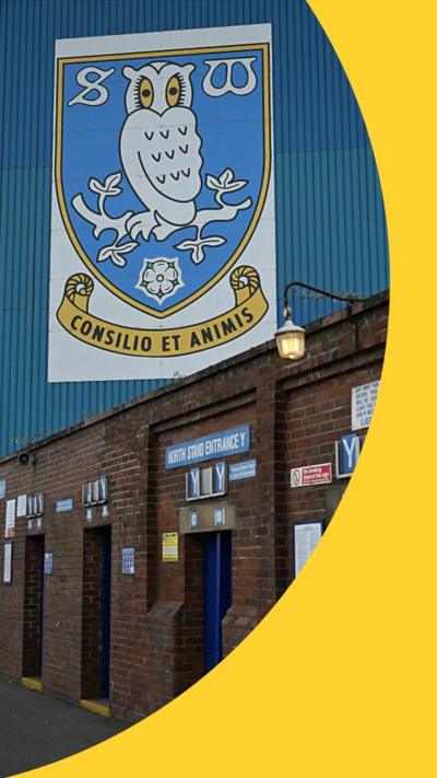 Sheffield Wednesday badge, featuring an owl, on a wall above entrances to the stadium 