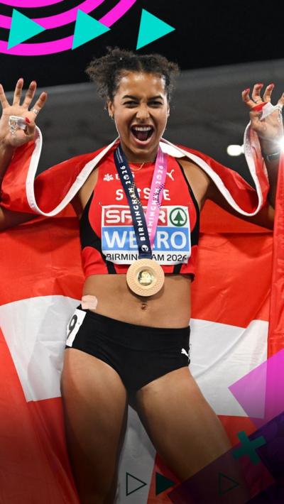 Audrey Werro celebrates gold with the Swiss flag behind her