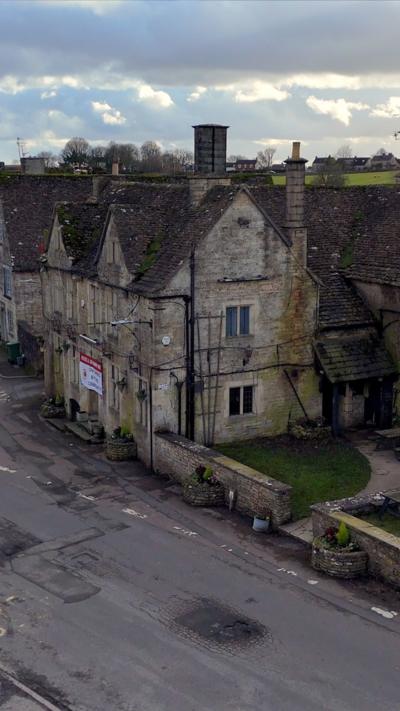 Aerial footage of pub with cloudy sky in the background