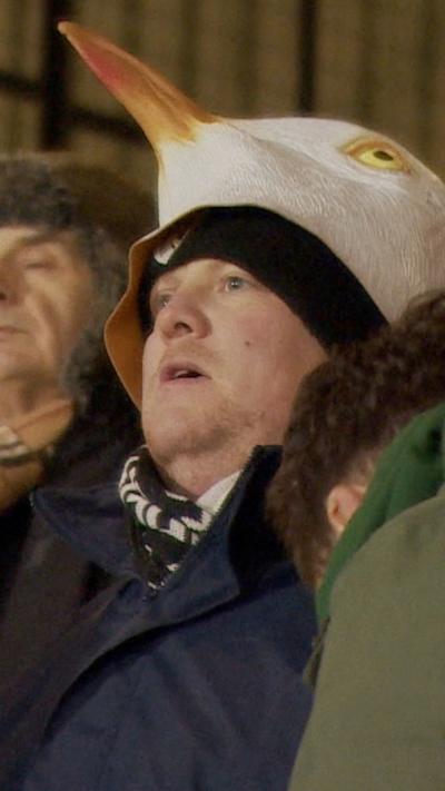 A Weston super Mare fan with a sea gull hat on his head
