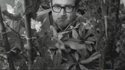 Image of James Burke, with some plants in the foreground