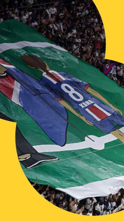 Large banner in crowd in tribute to Xana Martinez, daughter of Luis Enrique