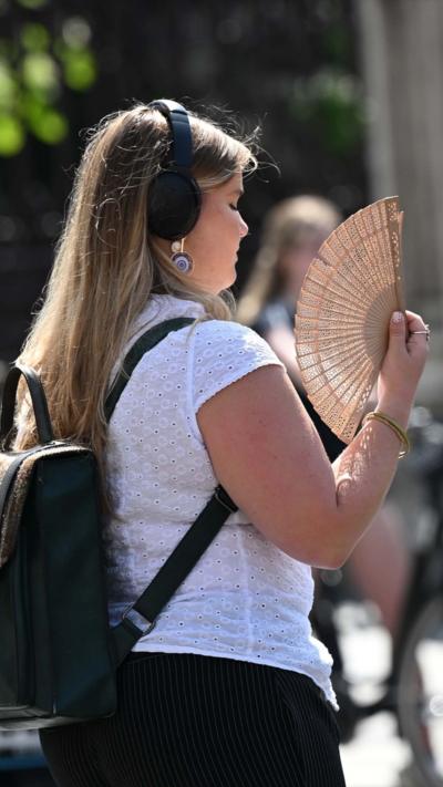 A woman with a fan