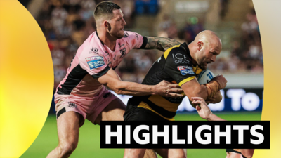 Paul McShane of York is tackled by Cade Cust of Hull FC