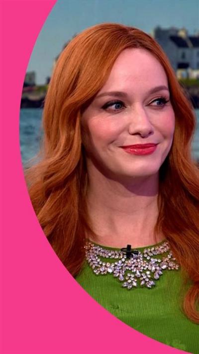Christina Hendricks wearing a bright green dress, smiling, in The One Show studio.