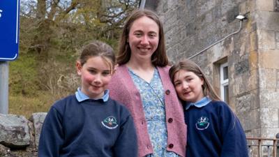 The teacher and two pupils outside Duror Primary in the Highlands.