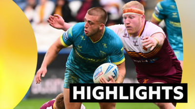 Mikey Lewis of Hull KR is tackled by Matty English of Huddersfield