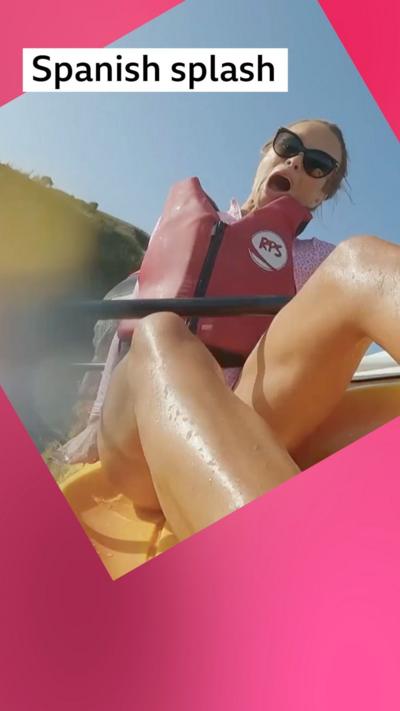 Amanda Holden falls out of a yellow kayak. She is wearing a red life jacket