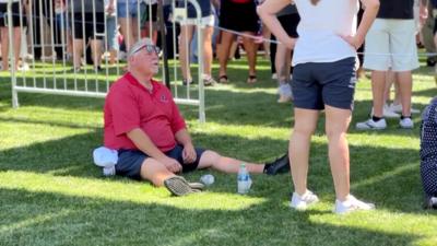 Man sitting in the grass on a hot day