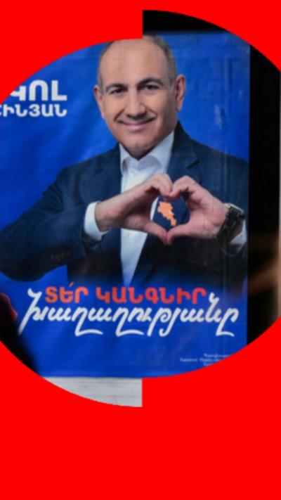 Street poster of a man wearing a blue suit doing a heart sign with his hands