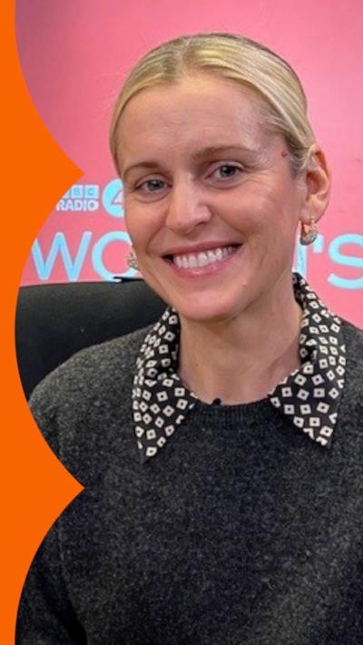 A woman, Denise Gough, with blonde hair and grey jumper smiling at the camera. 