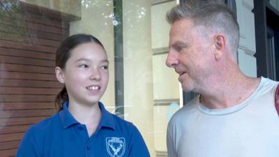 Young girl and her dad talking about Australia's social media ban