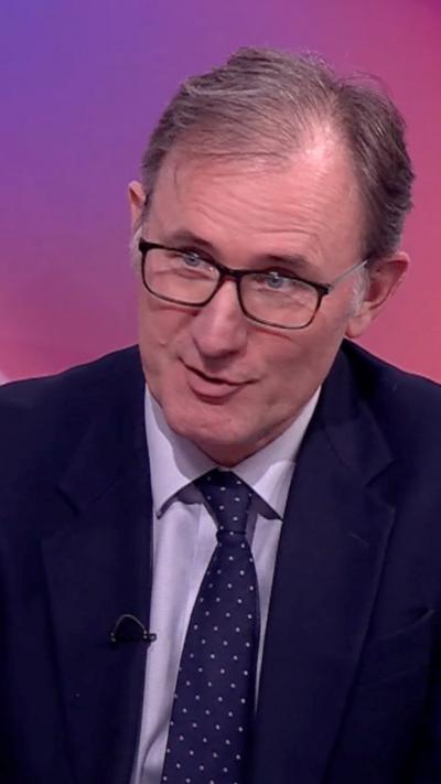 James Landale in suit and blue tie