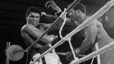 George Foreman in the boxing ring in 1974 with Muhammad Ali