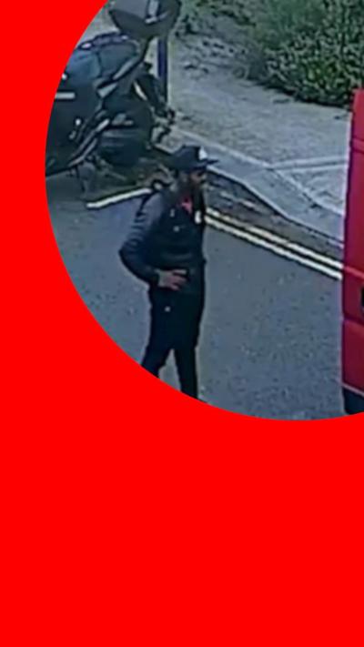 Yostin Mosquera stands on a street looking at red van