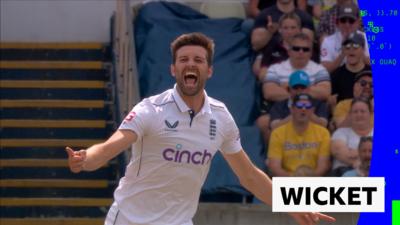 England's Mark Wood celebrates taking the wicket of Alzarri Joseph