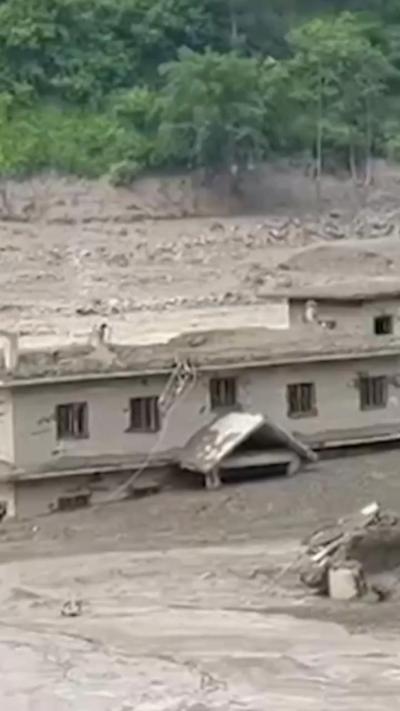 A building surrounded by mud.
