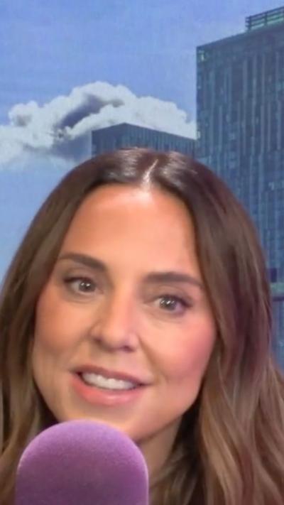 Melanie C speaking into a purple microphone