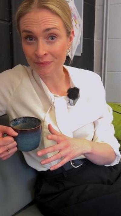 BBC reporter Esme Ashcroft wears a white shirt and holds a mug.