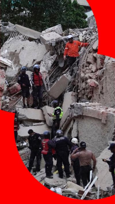 Rescuers gather round a collapsed building