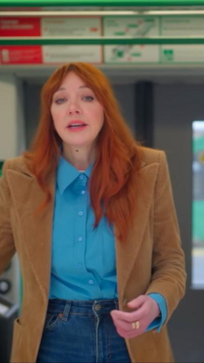 A woman with red hair on a train