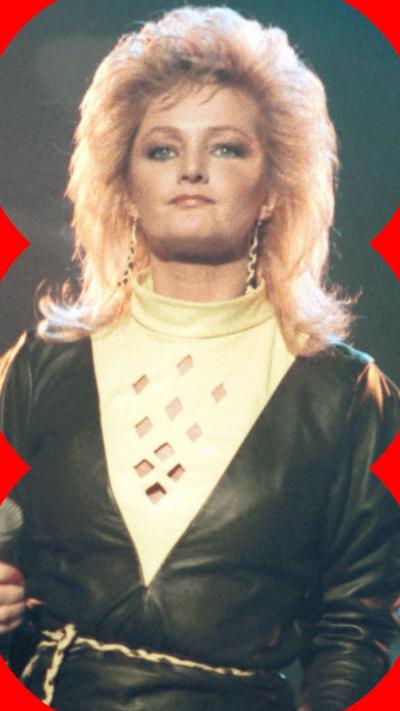 A woman with blonde hair stands on stage