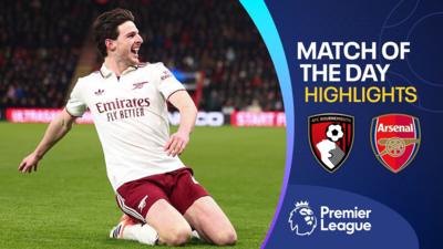 Declan Rice celebrates with a knee slide in white Arsenal kit