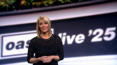 Kirsteen MacDonald stands in front of a banner saying Oasis live '25