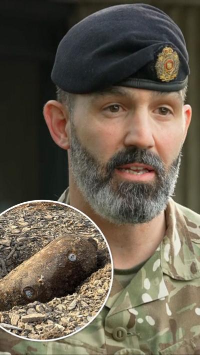Colonel Nick Handy looking right of camera, with the WW2 bomb inset