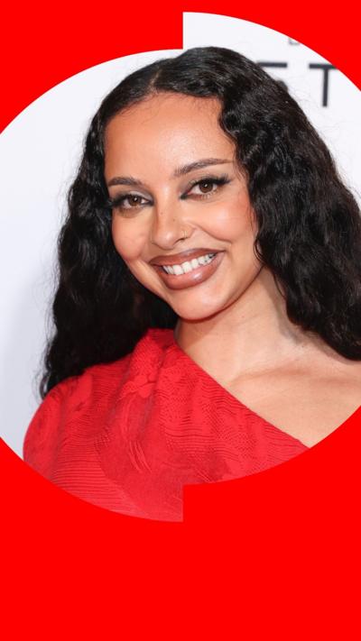 Singer Jade smiles - she has long wavy black hair