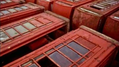Rows of old disused red telephone boxes led down on their sides.