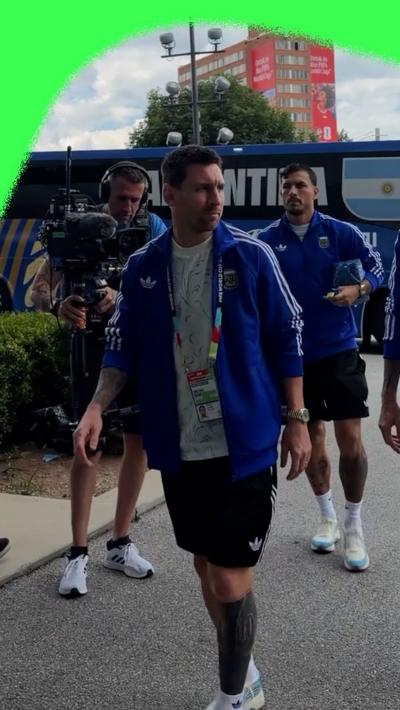 Lionel Messi in a blue jacket and black shorts as he arrives in the Atlanta Stadium for England v Argentina