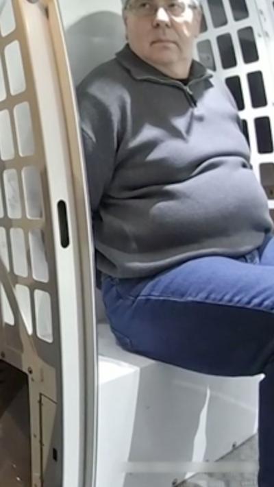 man in grey sweater sat on chair