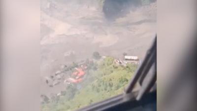 Aerial view of flooded area with houses seen in distance