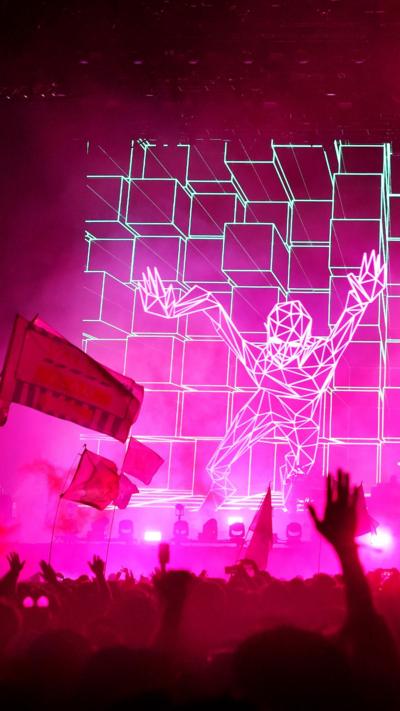 An animation of a person on a pink background plays as The Chemical Brothers perform at Glastonbury 2019 