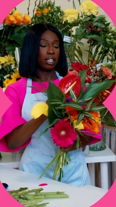 Woman with shoulder-length black hair holding a bunch of flowers