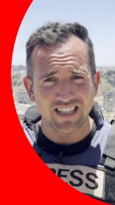 Hugo Bachega wearing a bullet proof vest with PRESS written on it
© BBC