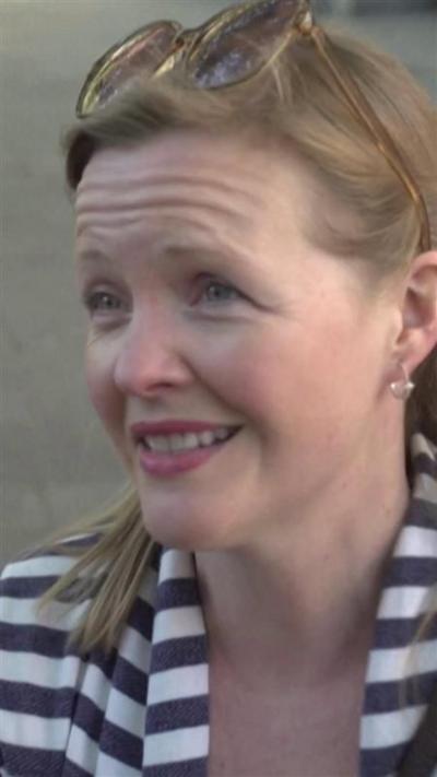 A woman with brown hair and a striped top