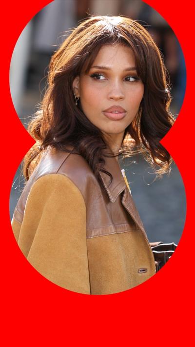 Nara Smith has brown hair ad is wearing a tan leather jacket.