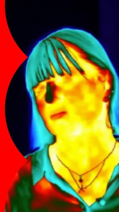 Therman image of a woman with long hair. Her nose is green.