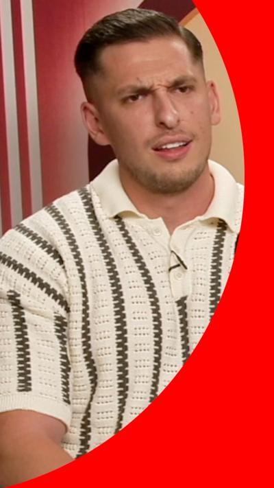 A man, wearing a striped  shirt, looking confused