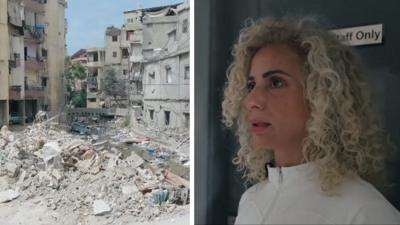 Rubble on left, woman with blonde curly hair on right