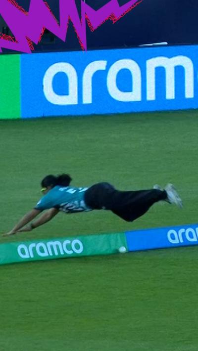 NZ fielder diving over the boundary rope