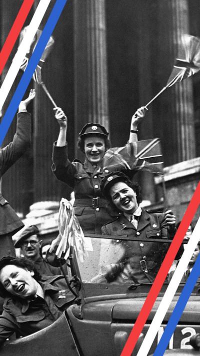 Women from the WRAC waving British flags from a car at the VE Day celebrations in Trafalgar Square.