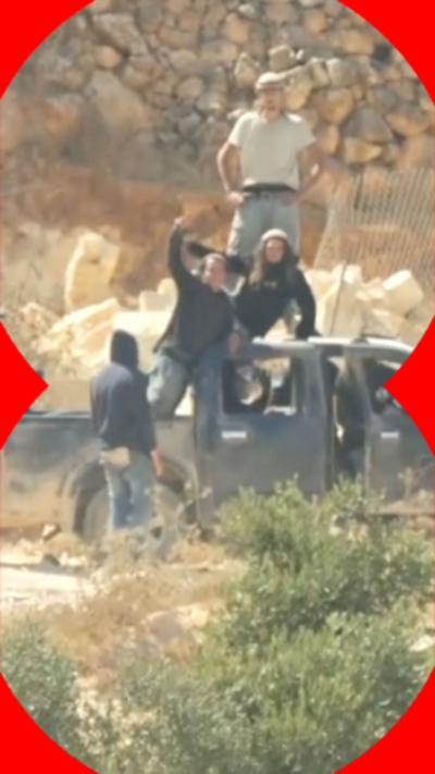Israeli settlers stood on top of a pickup truck