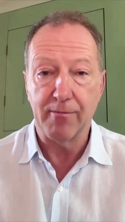Tom Baldwin wearing an open neck shirt