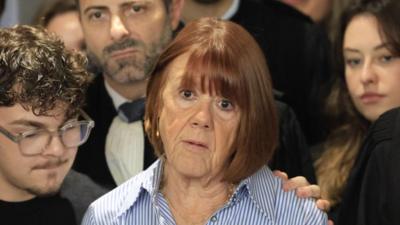 Gisèle Pelicot speaking outside court surrounded by onlookers 