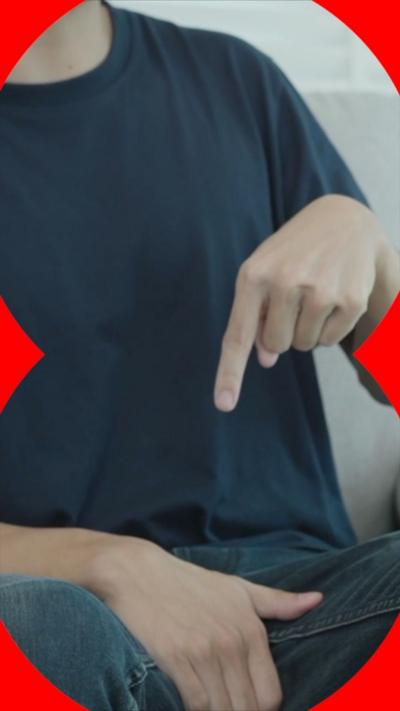A man points at his crotch area.
