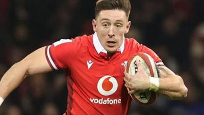 Josh Adams carries for Wales