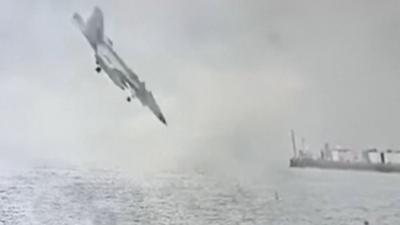 A US fighter jet is seen nose down moments before it crashes into the San Diego Bay.